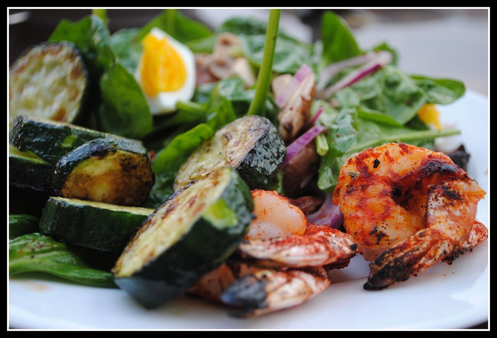 DSC_0496 A few grilled zucchini coins and shrimps on a spinach salad.