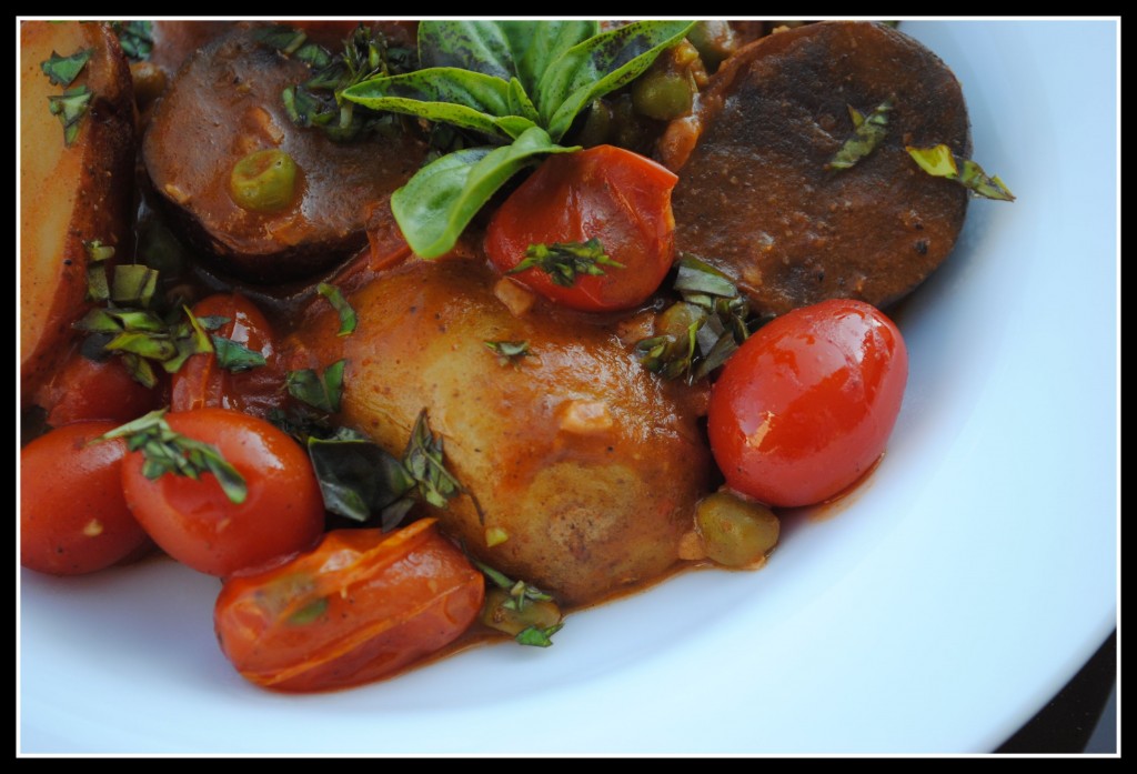 DSC_0088 A bowl of coconut potato curry with basil and cashews, topped with a sprig of fresh basil.